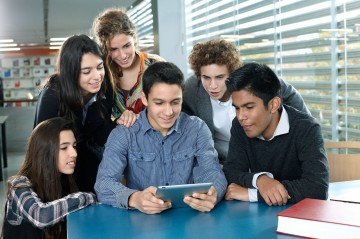 Group of teenagers looking at a digital tablet
